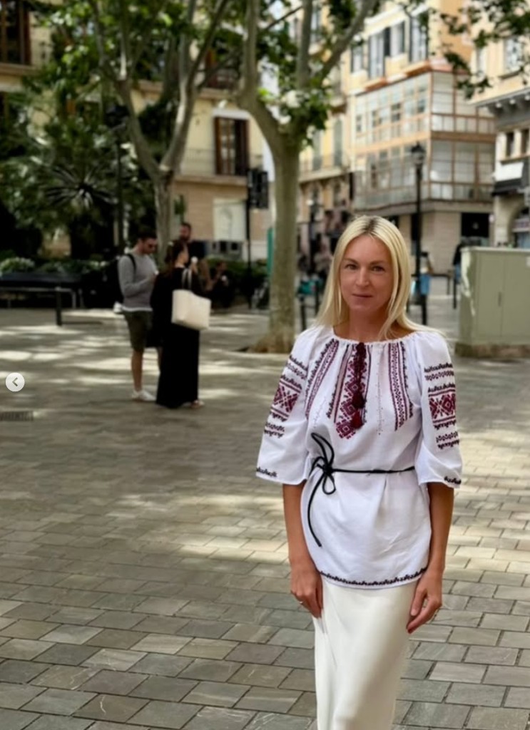 Alena Kulikova in an embroidered blouse in a city plaza
