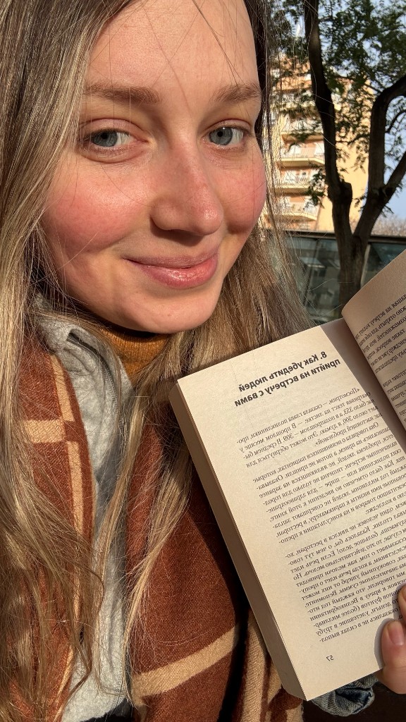 Lena reading a book outdoors