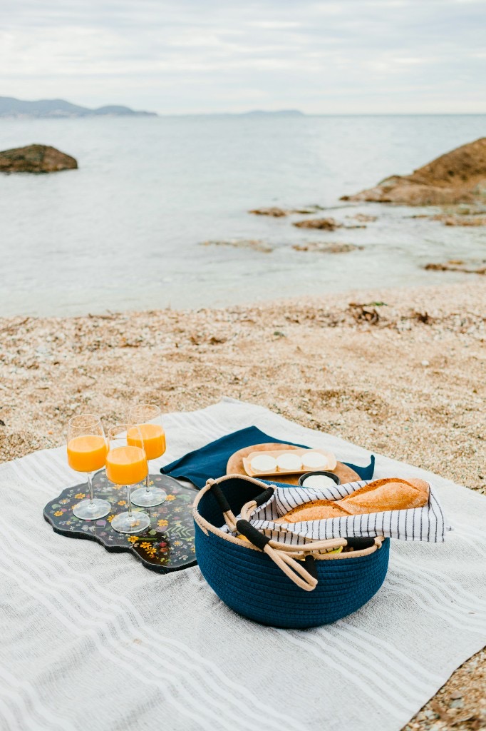 Picnic gatherings — beach spread, coastal view, macarons and a candlelit evening table
